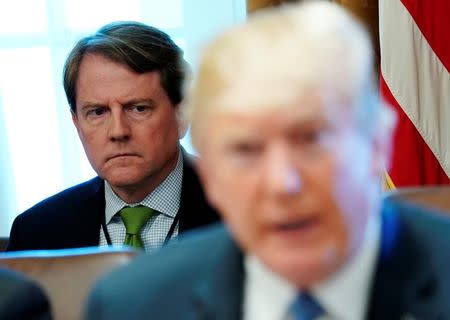 FILE PHOTO: White House Counsel Don McGahn sits behind U.S. President Donald Trump as the president holds a cabinet meeting at the White House in Washington, U.S. June 21, 2018. REUTERS/Jonathan Ernst