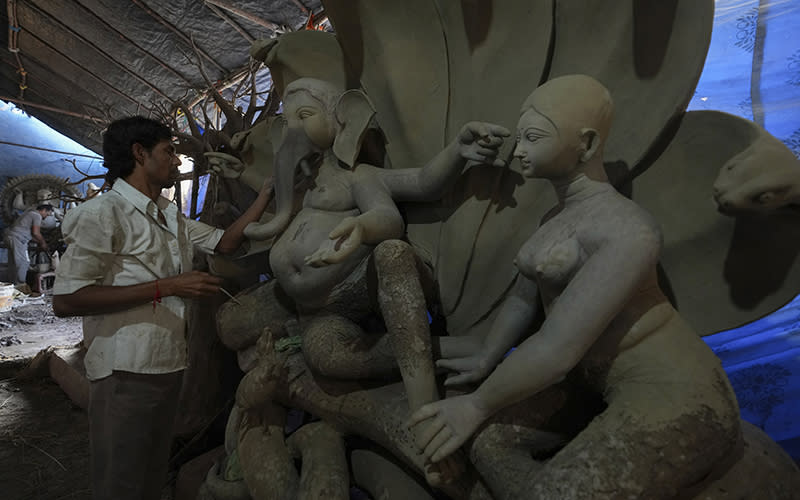 n artisan prepares eco-friendly idols of elephant-headed Hindu god Ganesha