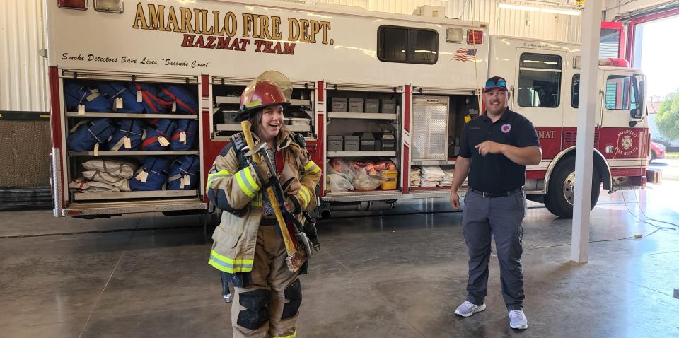 Casey Nelson, communications director for U.S. Rep. Ronny Jackson, gets a feel Wednesday of the sheer amount of equipment and its weight on a firefighter at Amarillo Fire Station No. 5.