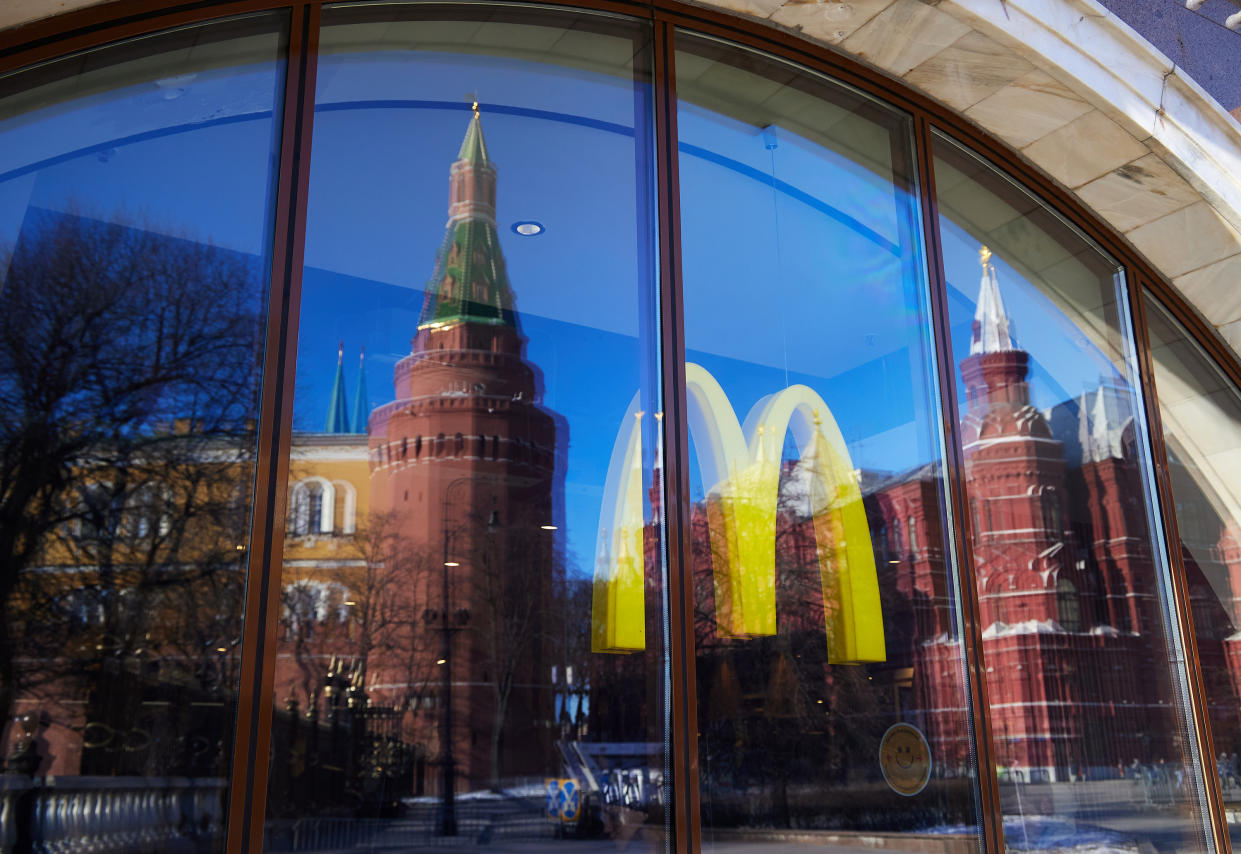 The Kremlin tower in Moscow is reflected in a McDonald's window showing the company's iconic golden arches.