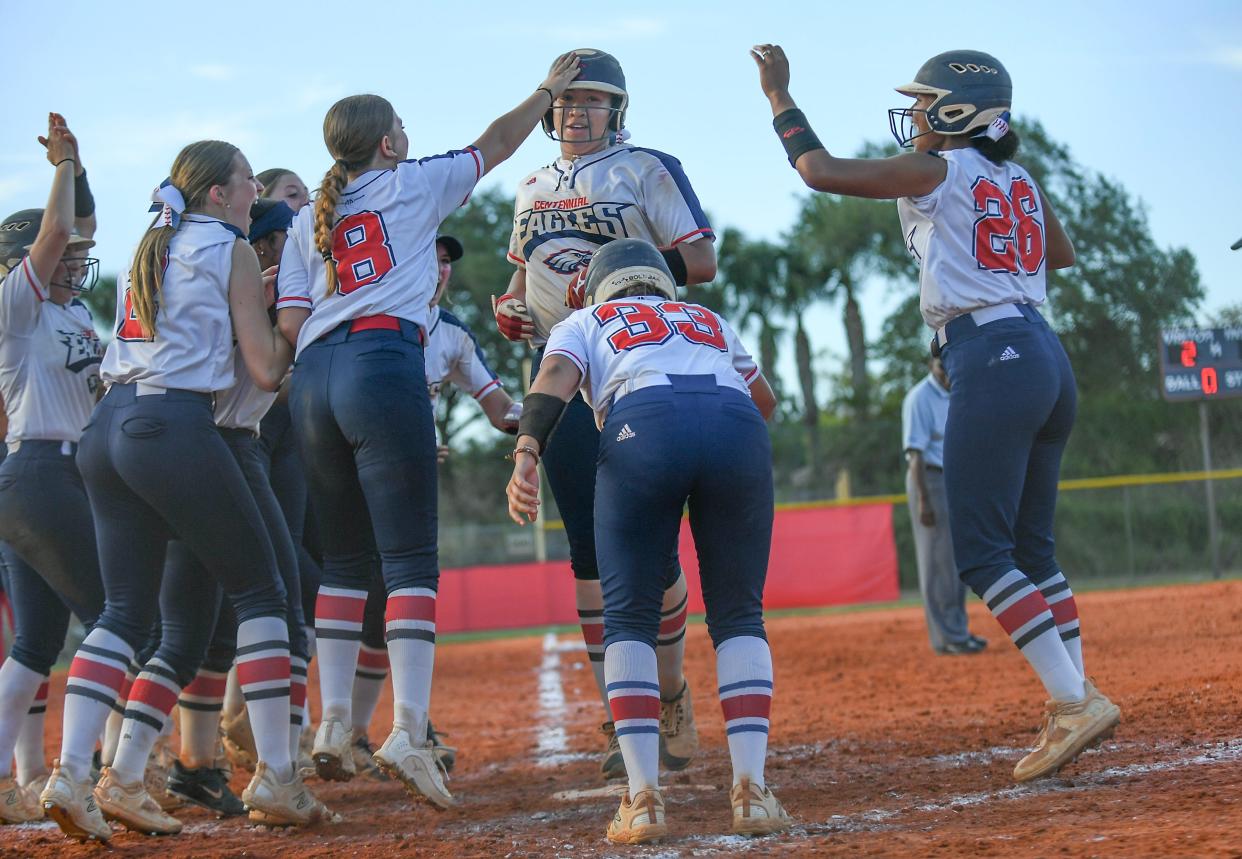 St. Lucie West Centennial senior Keyhara Alleyne (center) is greeted at home plate after hitting a home run to propel the Eagles to a 4-2 win over Treasure Coast at the District 11-7A title game Wednesday, May 1, 2024, at SLW Centennial High School in Port St. Lucie.