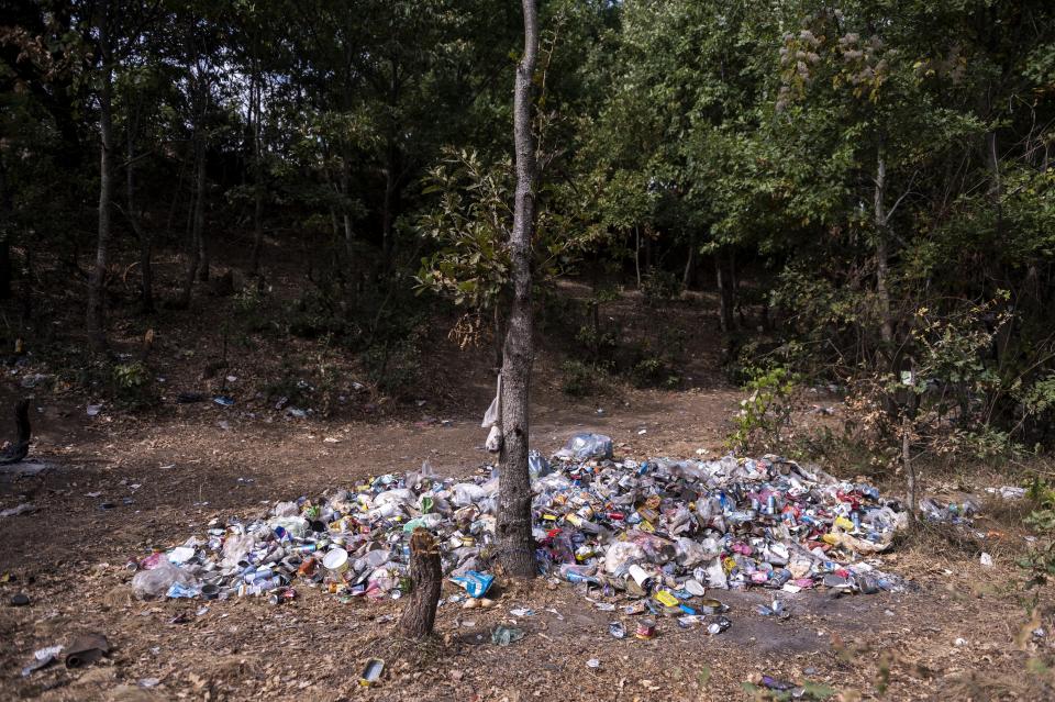 A pile of garbage inside a forest where migrants gather near Ieropigi village, northern Greece, at the Greek - Albanian border, on Tuesday, Sept. 28, 2021. A relatively smooth section of Greece's rugged border with Albania is turning into a major thoroughfare north for migrants in Greece seeking a better life in Europe's prosperous heartland. (AP Photo/Giannis Papanikos)