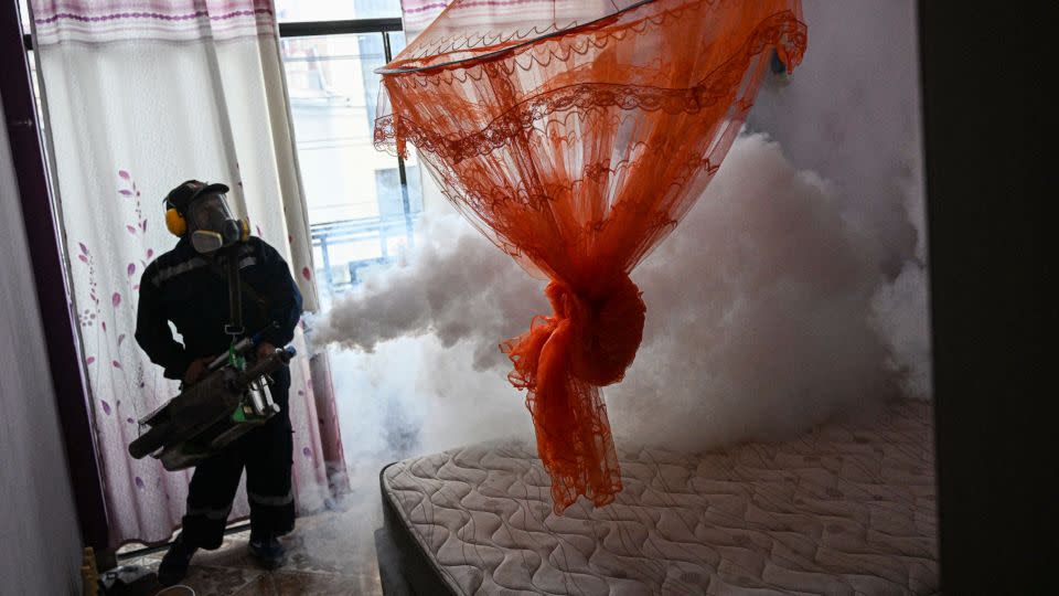 A worker fumigates a house against the Aedes aegypti mosquito to prevent the spread of dengue fever in a neighborhood in Piura, northern Peru, on June 11, 2023. - Ernesto Benavides/AFP/Getty Images