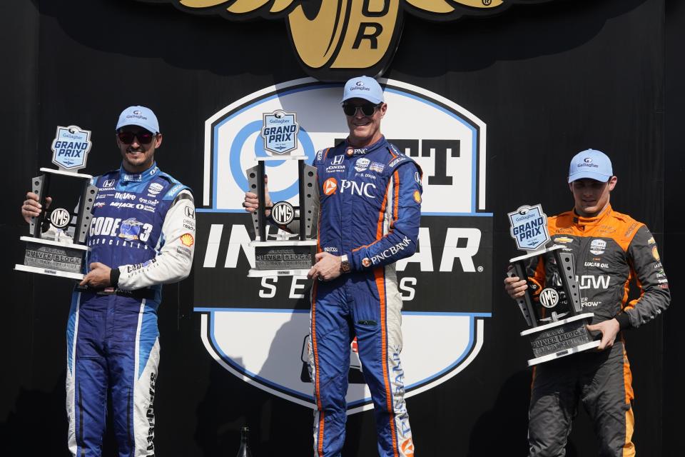 Scott Dixon, middle, of New Zealand, Graham Rahal, left, and Pato O'Ward, of Mexico, hold trophies after the IndyCar Indianapolis GP auto race at Indianapolis Motor Speedway, Saturday, Aug. 12, 2023, in Indianapolis. Dixon won the racer, Rahal finished second and O'Ward finished third. (AP Photo/Darron Cummings)