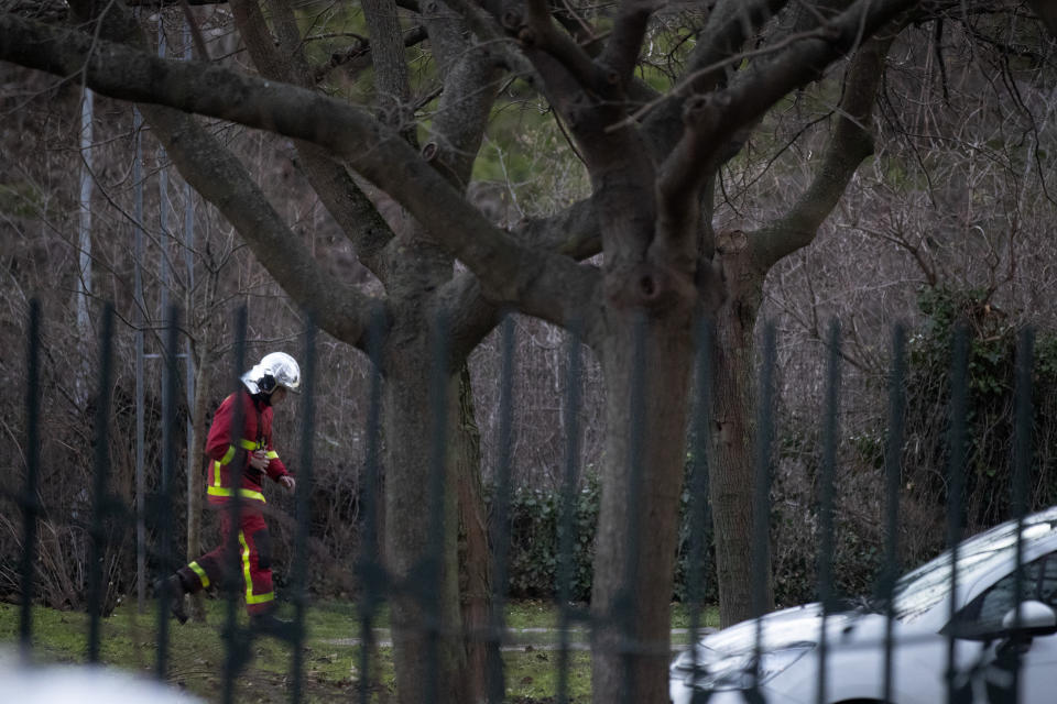 A rescue worker walks in a park after a man attacked passerby Friday Jan.3, 2020 in Villejuif, south of Paris. A man armed with a knife rampaged through a Paris park attacking passers-by seemingly at random Friday, killing at least one person and injuring two others before police shot him dead, officials said. (AP Photo/Michel Euler)