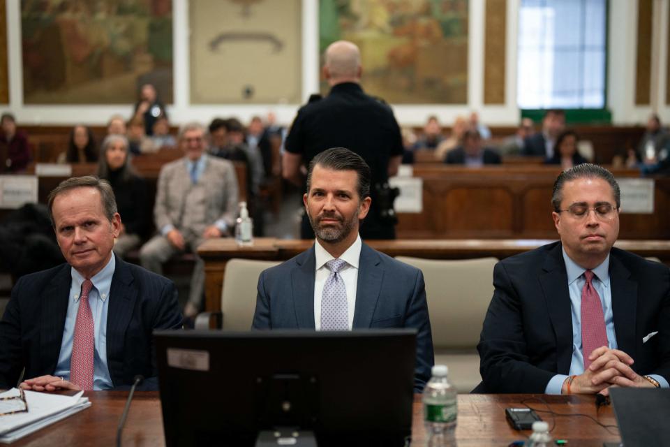 Donald Trump Jr., center, sits in the courtroom before testifying during the Trump Organization civil fraud trial at the New York State Supreme Court in New York City on Nov. 13, 2023.