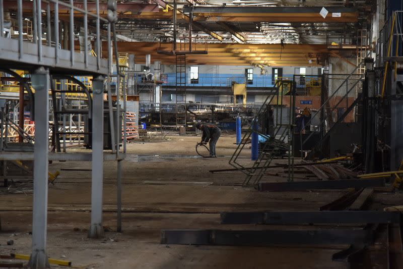 An employee prepares a facility for producing fire trucks, as the factory was relocated from Chernihiv region to Lviv amid Russia's invasion