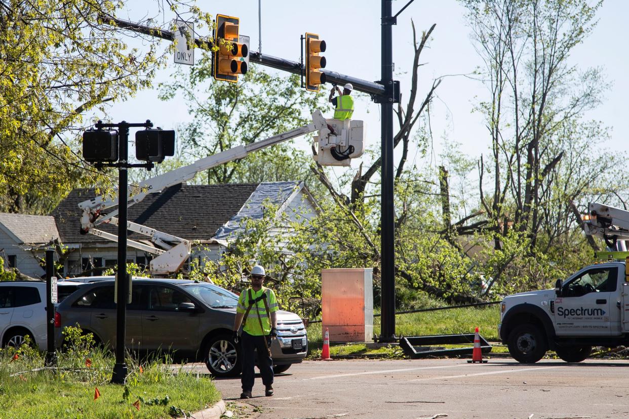 Workers repair tornado damage on Lovers Lane at Romance Road in Portage on Wednesday, May 8, 2024.