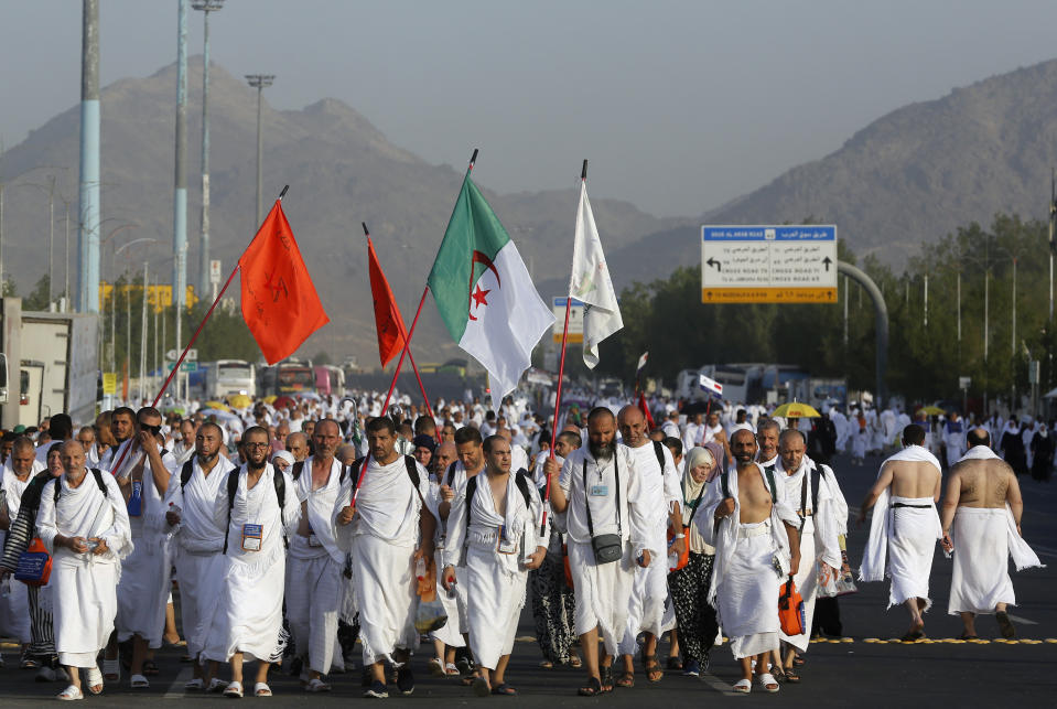 Algerian pilgrims march towards the Mountain of Mercy, on the Plain of Arafat, during the annual hajj pilgrimage, near the holy city of Mecca, Saudi Arabia, Saturday, Aug. 10, 2019. More than 2 million pilgrims were gathered to perform initial rites of the hajj, an Islamic pilgrimage that takes the faithful along a path traversed by the Prophet Muhammad some 1,400 years ago. (AP Photo/Amr Nabil)