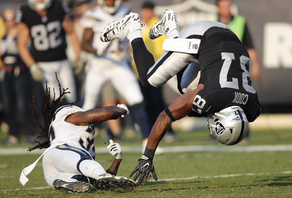 <p>Oakland Raiders tight end Jared Cook (87) flips forward over Los Angeles Chargers defensive back Brandon Facyson during the second half of an NFL football game in Oakland, Calif., Sunday, Nov. 11, 2018. (AP Photo/John Hefti) </p>