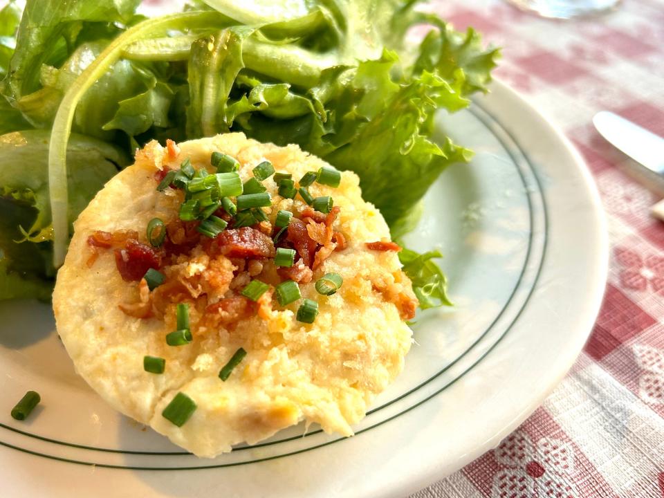 At Cafe Seiche on Madeline Island, the rich yet airy savory trout cake is made with a blend of goat cheese and cream cheese with herbs and a topping of crumbled bacon and chives.