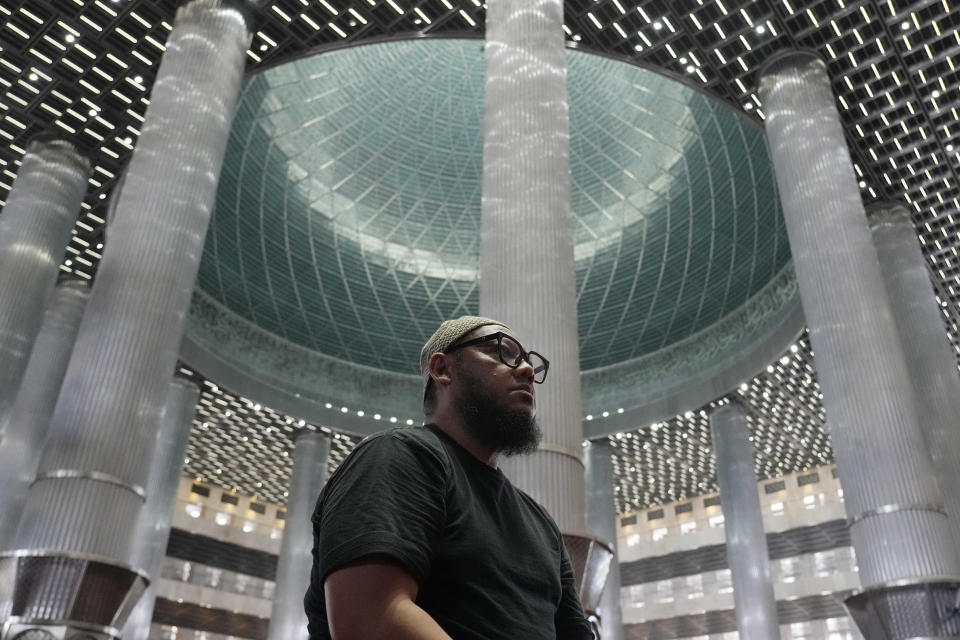 A Muslim sits while waiting for the time to break his fast during the first day of Ramadan at the Istiqlal Mosque in Jakarta, Indonesia, Tuesday, March 12, 2024. (AP Photo/Achmad Ibrahim)