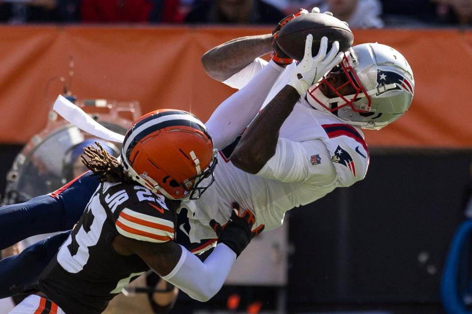 Oct 16, 2022; Cleveland, Ohio, USA; New England Patriots wide receiver DeVante Parker (1) makes a first down reception as Cleveland Browns cornerback Martin Emerson Jr. (23) tackles him during the first quarter at FirstEnergy Stadium. Mandatory Credit: Scott Galvin-USA TODAY Sports