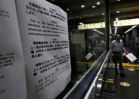 A note written in several languages, announcing last train services ending earlier due to Typhoon Trami, is displayed at East Japan Railway Company's station in Tokyo, Japan, September 30, 2018. REUTERS/Issei Kato