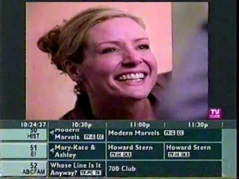 A screenshot of the TV Guide channel of a smiling face from a commercial with some channels scrolling by underneath it 