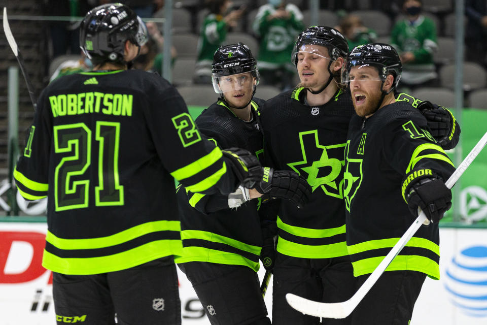 Dallas Stars center Joe Pavelski, right, celebrates with teammates after scoring a goal during the second period of an NHL hockey game against the Columbus Blue Jackets Saturday, April 17, 2021, in Dallas. (AP Photo/Sam Hodde)