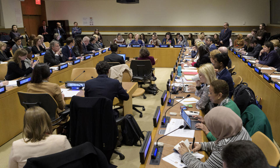 In this photo provided by the United Nations, former U.S. Secretary of State Hillary Clinton, back of room just left of center, delivers the keynote speech at an event entitled "Group of Friends of Afghanistan," Tuesday, March 10, 2020, at United Nations headquarters. The event was organized by the Permanent Mission of Afghanistan to the United Nations. (Manuel Elias/The United Nations via AP)