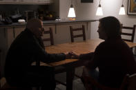 Harry Bruell, left, and wife, Jenny, hold hands while chatting in their home in Santa Barbara, Calif., Wednesday, March 9, 2022. Their daughter, Taya, killed herself when she was 14. Taya was a bright, precocious student who had started struggling with mental health issues at about 11, according to her father. At the time, the family lived in Boulder, Colorado where Taya was hospitalized at one point for psychiatric care but kept up the trappings of a model student. (AP Photo/Jae C. Hong)