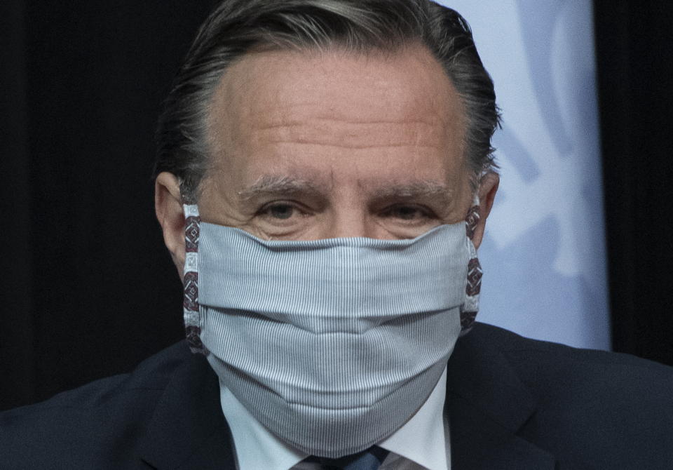 Quebec Premier Francois Legault arrives at a news conference on the COVID-19 pandemic wearing a mask, Tuesday, May 12, 2020 at the legislature in Quebec City. (Jacques Boissinot/The Canadian Press via AP)