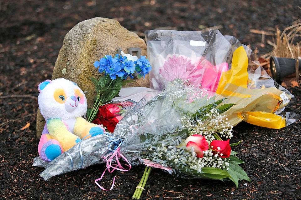 Flowers were left outside the Summer Street home in Duxbury where two children were strangled on Tuesday, Jan. 24, 2023.