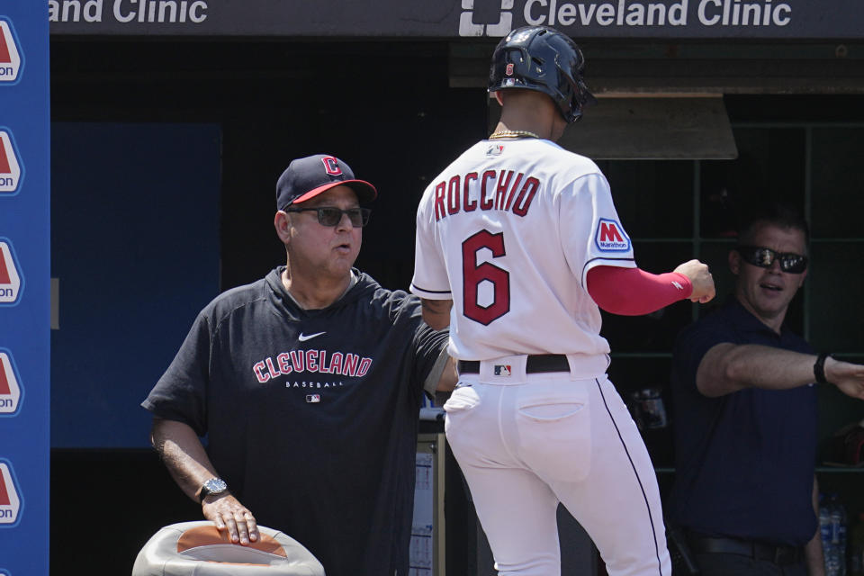 Cleveland Guardians' Brayan Rocchio is greeted at the dugout by manager Terry Francona, left, after scoring in the fifth inning of a baseball game against the Toronto Blue Jays, Thursday, Aug. 10, 2023, in Cleveland. (AP Photo/Sue Ogrocki)