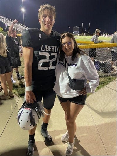 Liberty High School's Brady Cannon poses with sister and third grade teacher Payton Cannon after a football game.