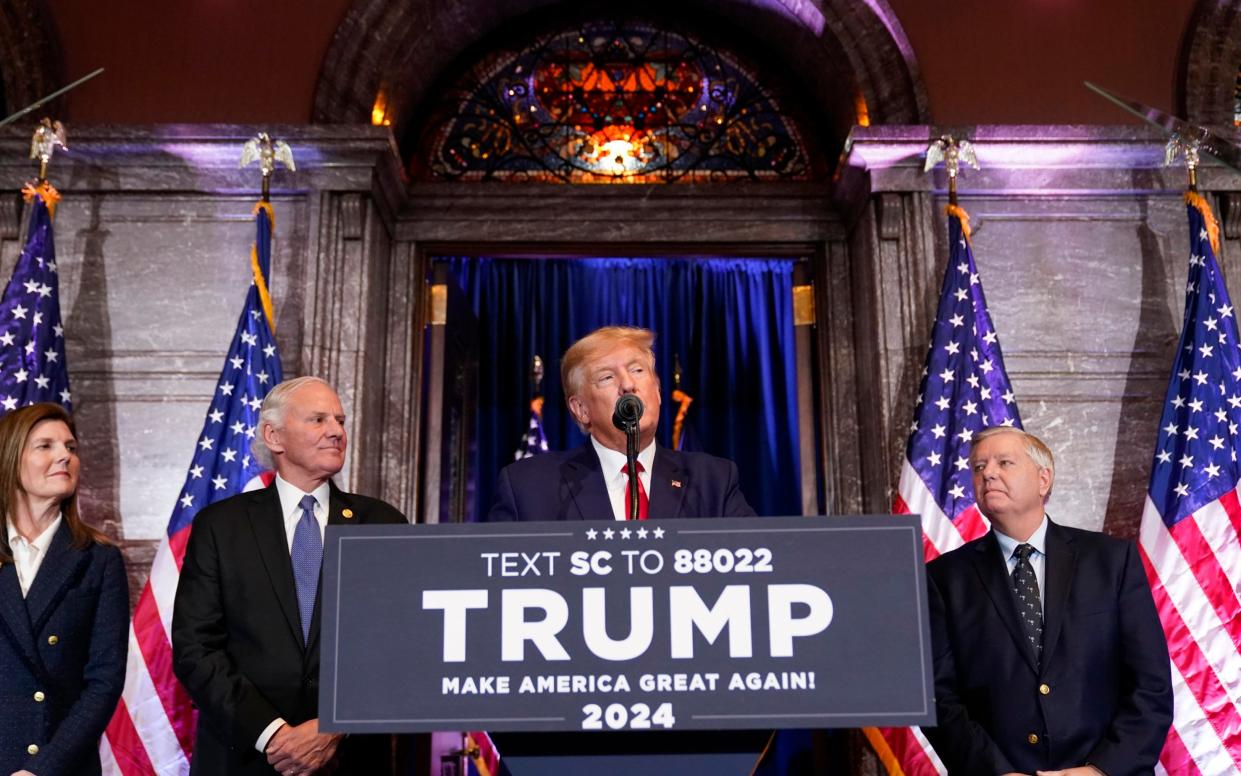 Donald Trump speaks during the campaign event at the South Carolina Statehouse in Columbia, with Senator Lindsey Graham, right - AP