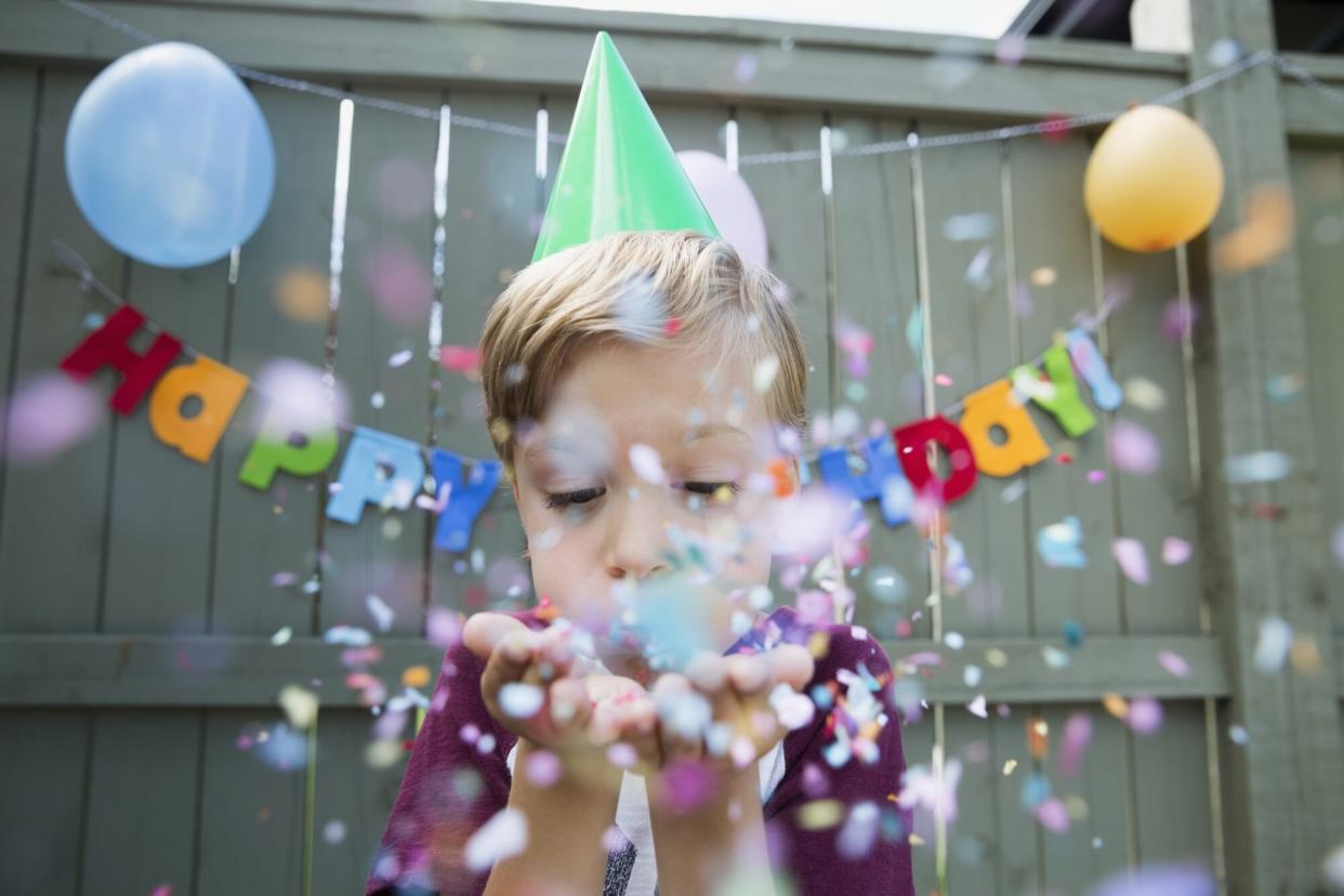 Young Boy Blowing Birthday Confetti