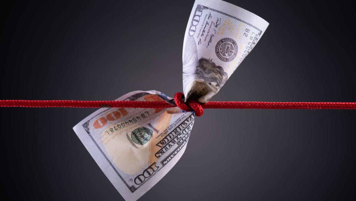 <span class="caption">When money comes with strings attached, it doesn't always do the most good.</span> <span class="attribution"><a class="link " href="https://www.gettyimages.com/detail/photo/american-dollar-tied-up-in-red-rope-knot-on-dark-royalty-free-image/1148723979" rel="nofollow noopener" target="_blank" data-ylk="slk:spukkato/iStock via Getty Images Plus;elm:context_link;itc:0;sec:content-canvas">spukkato/iStock via Getty Images Plus</a></span>