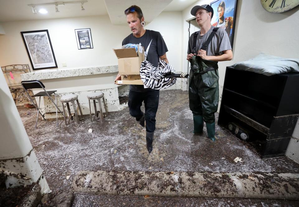 Robert Bergener, left, and Brogan Darling, with Total Flood and Fire Restoration, work in a flooded home in Draper on Friday, Aug. 4, 2023. Draper Mayor Troy Walker declared a state of emergency due to flooding. | Kristin Murphy, Deseret News