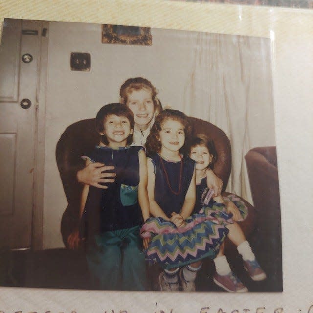 Schumann poses with her three children in this undated photograph.