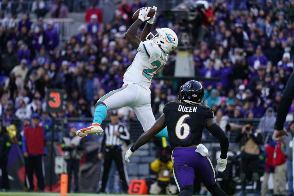 Miami Dolphins running back De'Von Achane (28) catches a touchdown pass as Baltimore Ravens linebacker Patrick Queen (6) defends during the second half of an NFL football game in Baltimore, Sunday, Dec. 31, 2023. (AP Photo/Matt Rourke)