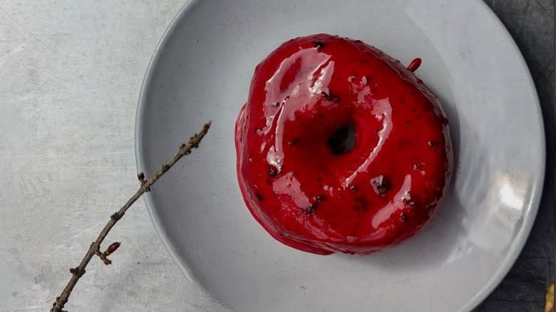 Red donut on gray plate