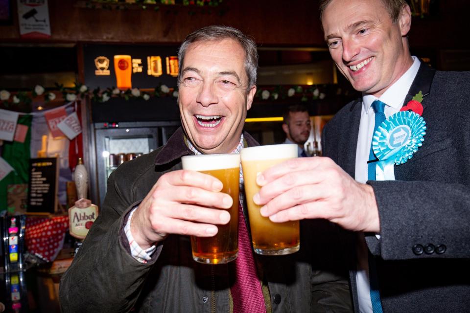 Brexit Party leader Nigel Farage stops for a pint of beer with the party's candidate for Ashfield Martin Daubney during campaigning (PA)