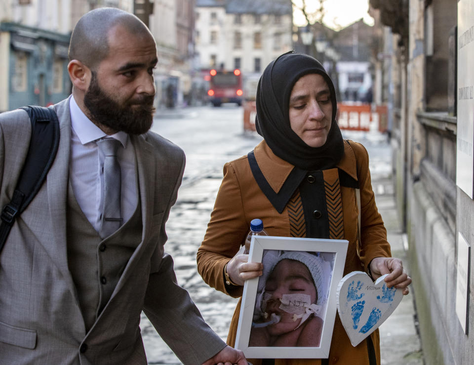 Karwan (left) and Shokhan, the parents of three-month-old Midrar Ali, arrive ahead of a hearing at The Family Court in Preston.