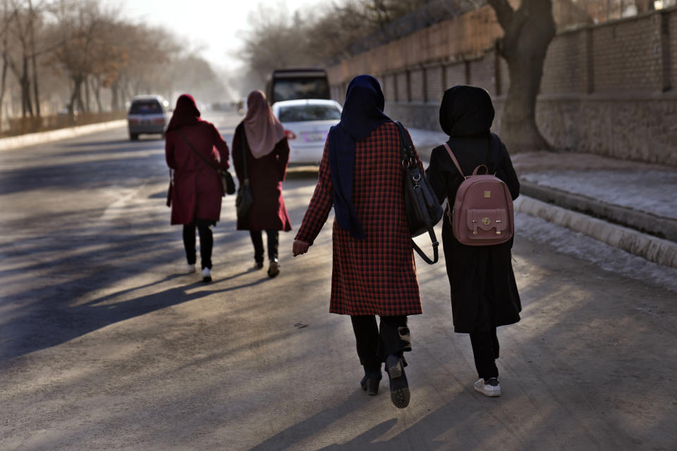 Afghan students walk toward their university in Kabul, Afghanistan, Saturday, Feb. 26, 2022. Kabul University, among Afghanistan’s oldest and most revered institutions of higher education, reopened Saturday six months after the Taliban retook the country. There were new restrictions in place, however, including gender segregation and mandatory Islamic dress. (AP Photo/Hussein Malla)