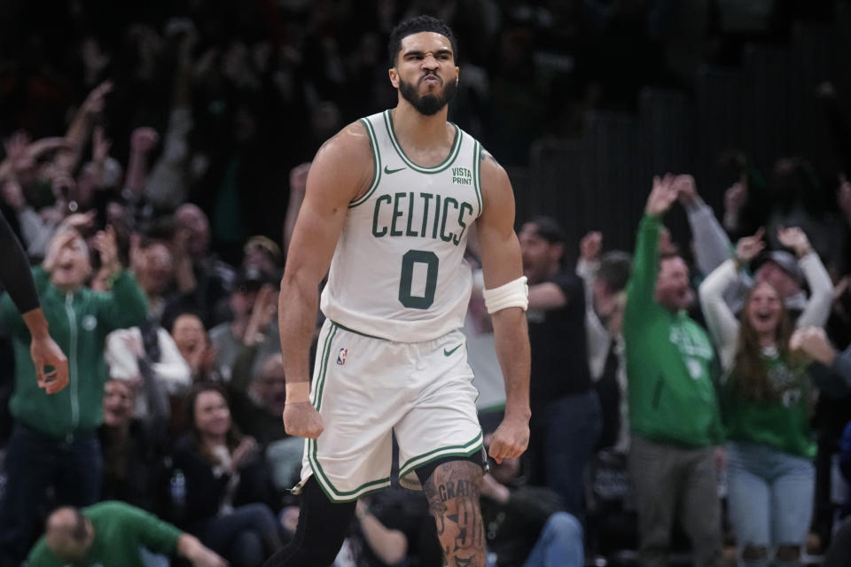 Boston Celtics forward Jayson Tatum (0) celebrates after making a 3-pointer during overtime of the team's NBA basketball game against the Minnesota Timberwolves, Wednesday, Jan. 10, 2024, in Boston. Tatum scored 45 points in the 127-120 Celtics win. (AP Photo/Charles Krupa)