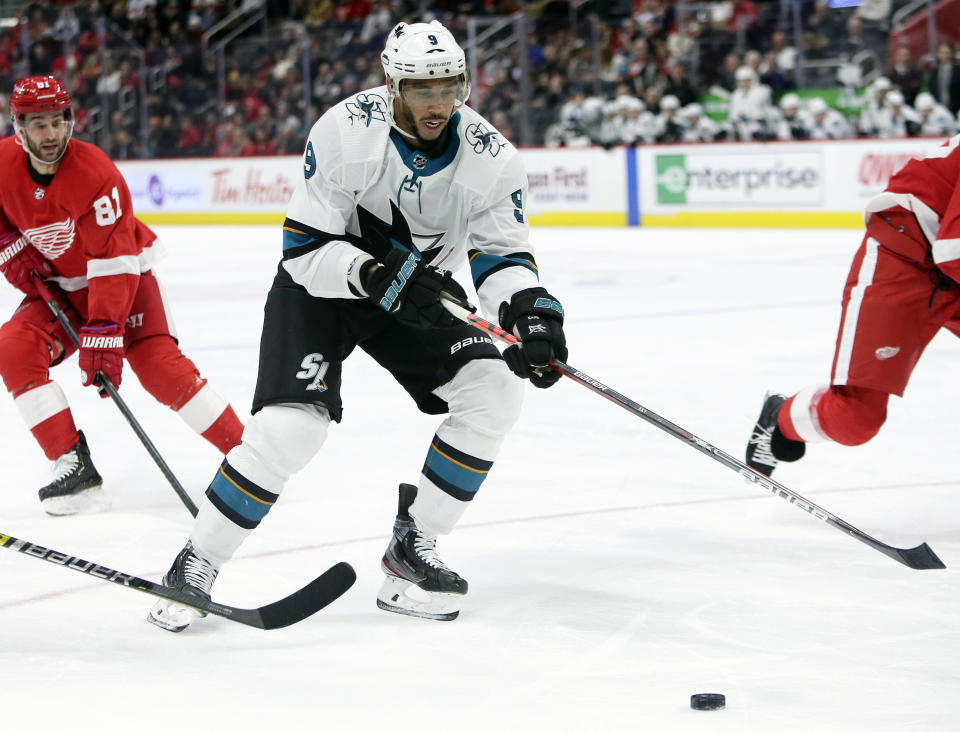 File - In this Dec. 31, 2019, file photo, San Jose Sharks left wing Evander Kane (9) looks to pass the puck while being pursued by Detroit Red Wings center Frans Nielsen (81), of Denmark, during the first period of an NHL hockey game in Detroit. Seven current or former black NHL players have formed the Hockey Diversity Alliance to fight racism and intolerance in the sport. Akim Aliu and San Jose's Kane will lead the group, which also includes Trevor Daley, Matt Dumba, Wayne Simmonds, Chris Stewart and recently retired Joel Ward. (AP Photo/Duane Burleson, File)