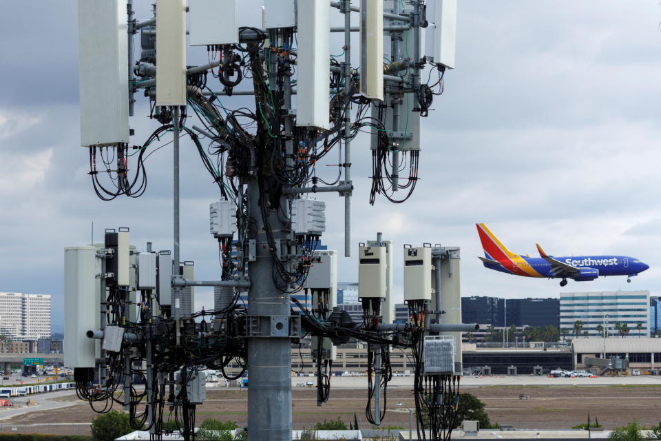 A Southwest commercial aircraft flies past a cell phone tower as it approaches to land at John Wayne Airport in Santa Ana, California U.S. January 18, 2022. U.S. airlines said on Wednesday the rollout of new 5G services was having only a minor impact on air travel as the U.S. Federal Aviation Administration (FAA) said it has issued new approvals to allow more low-visibility landings.    REUTERS/Mike Blake