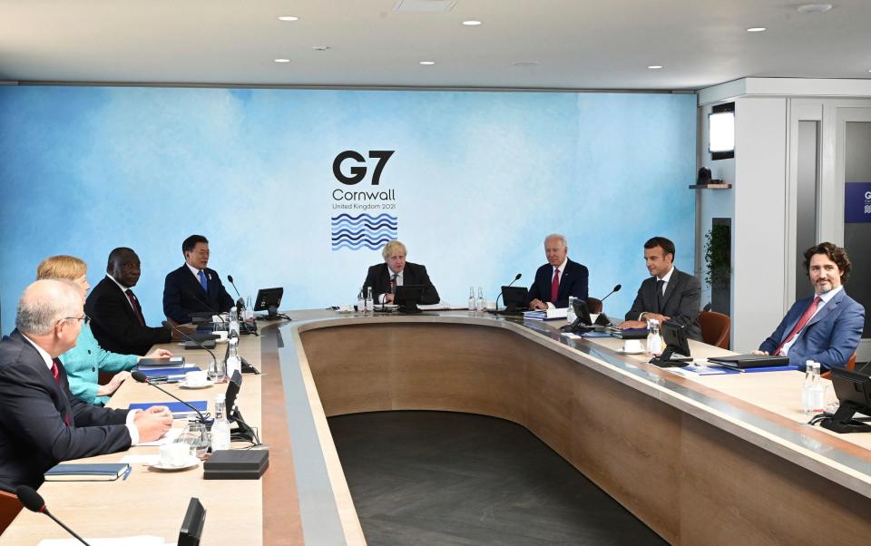 Prime Minister Boris Johnson, centre, with from left, Australia's Prime Minister Scott Morrison, German Chancellor Angela Merkel, South Africa's President Cyril Ramaphosa, South Korea's President Moon Jae-in, US President Joe Biden, French President Emmanuel Macron and Canadian Prime Minister Justin Trudeau during the G7 summit in Cornwall - Leon Neal/Getty Pool