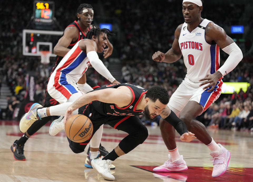 Toronto Raptors guard Fred VanVleet (23) gets tripped as Detroit Pistons guard Jaden Ivey (23) defends and Pistons center Jalen Duren (0) watches during the first half of an NBA basketball game Friday, March 24, 2023, in Toronto. (Frank Gunn/The Canadian Press via AP)