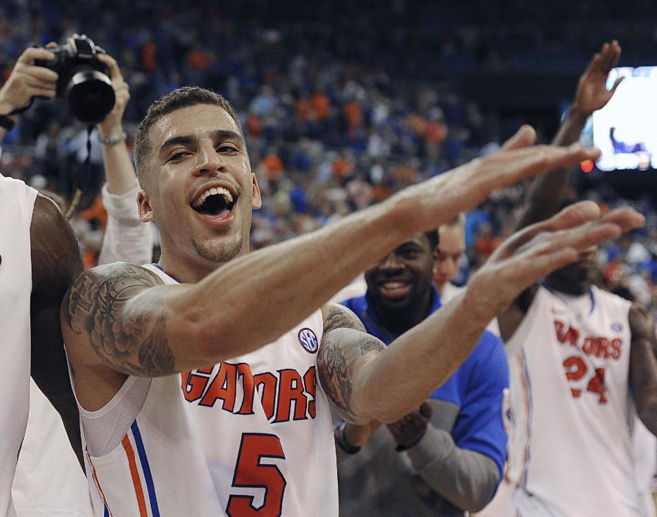 Florida guard Scottie Wilbekin (5) does the gator chomp after Florida defeated Auburn 71-66 during an NCAA college basketball game Wednesday Feb. 19, 2014 in Gainesville, Fla. (AP Photo/Phil Sandlin)