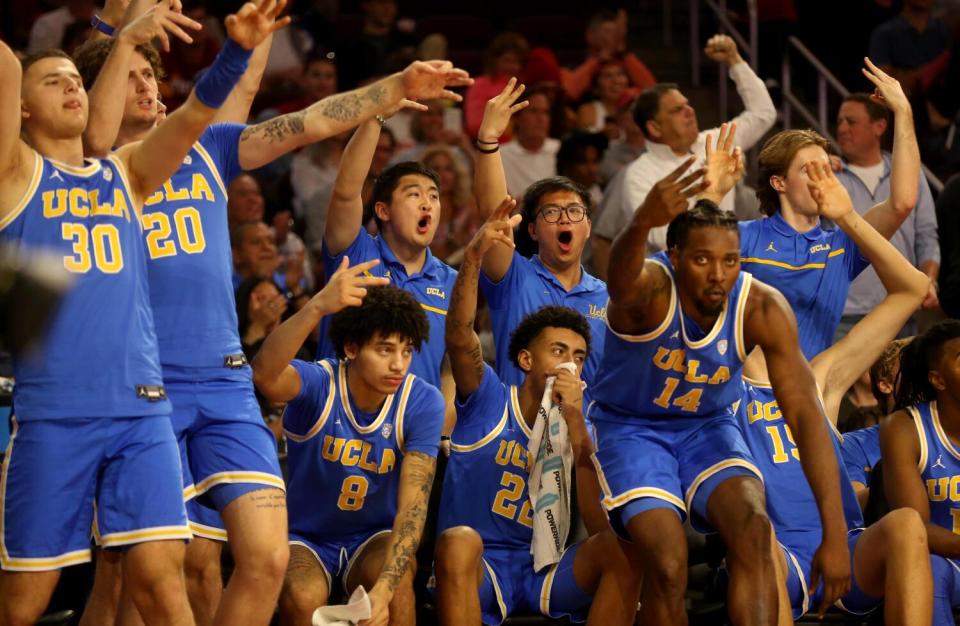 UCLA players celebrate a three-pointer by Lazar Stefanovic in the final two minutes Saturday against USC.