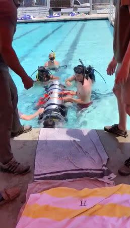 A device by Elon Musk's SpaceX and The Boring Company, designed to help rescue the remaining members of a soccer team trapped in a flooded cave in Chiang Rai, Thailand, is being tested in a swimming pool in Los Angeles, California, U.S., in this still image taken from an undated video obtained from social media. MANDATORY CREDIT. Twitter @elonmusk/via REUTERS