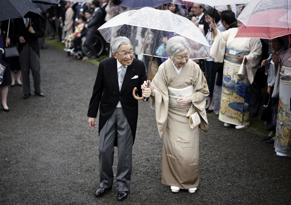 FILE - In this Nov. 9, 2018, file photo, Japan's Emperor Akihito, left, and Empress Michiko, right, greet the guests during the autumn garden party at the Akasaka Palace imperial garden in Tokyo. On May 1, 2019, when Crown Prince Naruhito becomes the new emperor. Naruhito will receive a much more important inheritance: The deep respect and affection his father, soon-to-abdicate Emperor Akihito, has accumulated over his three-decade reign. (AP Photo/Eugene Hoshiko, File)