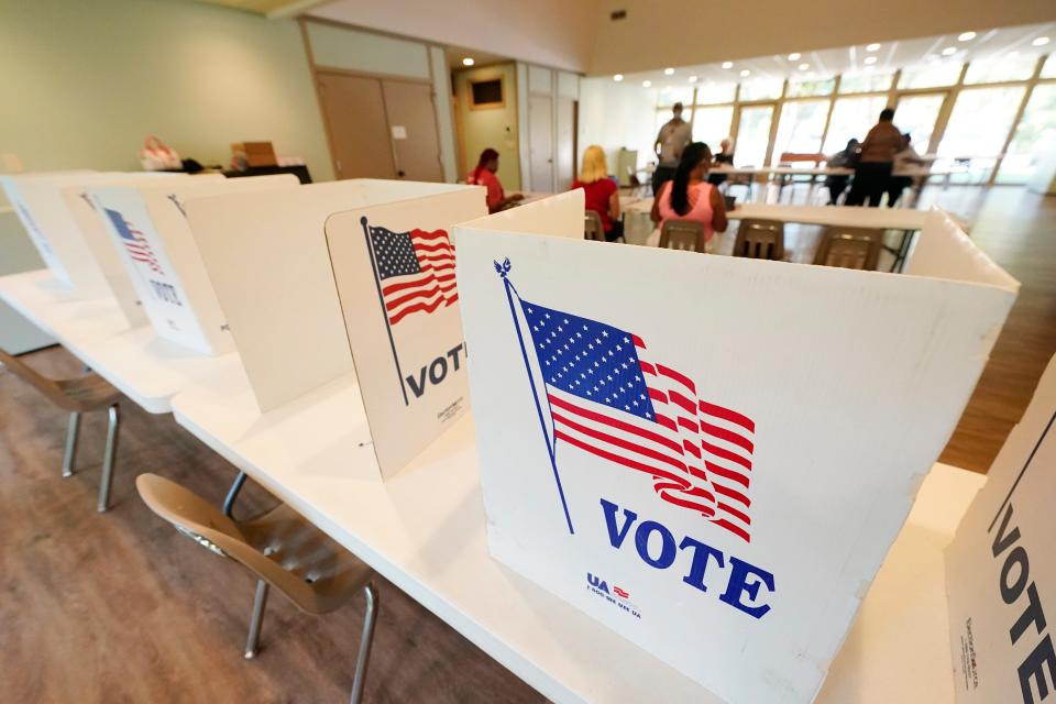 Empty poll kiosks await voters at the Mississippi Second Congressional District Primary election precinct on June 7, 2022, in Jackson, Miss. Prosecutors are trying to stop the menacing of election workers as violent and graphic threats are deluging workers even in normally quiet periods between elections.