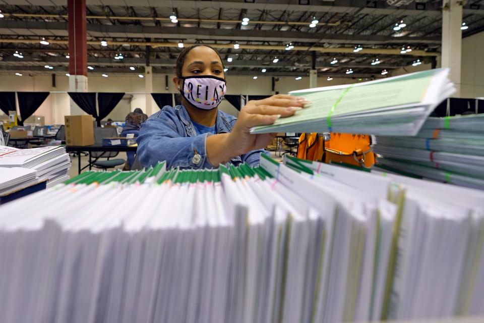 Harris County election worker Romanique Tillman prepares mail-in ballots to be sent out to voters Tuesday, Sept. 29, 2020, in Houston. 