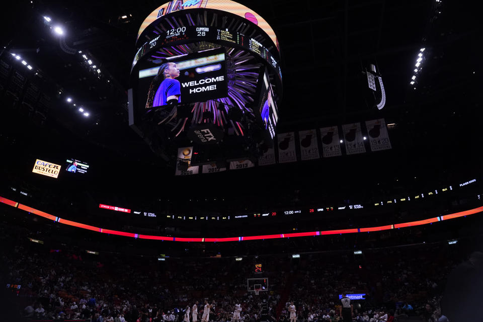 Brittney Griner is welcomed home on a large screen during the first half of an NBA basketball game between the Miami Heat and the Los Angeles Clippers, Thursday, Dec. 8, 2022, in Miami. Griner was released from a Russian prison in a prisoner swap earlier in the day. (AP Photo/Wilfredo Lee)