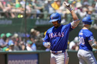 Texas Rangers' Marcus Semien celebrates after hitting a solo home run against the Oakland Athletics during the third inning in the first baseball game of a doubleheader Wednesday, May 8, 2024, in Oakland, Calif. (AP Photo/Godofredo A. Vásquez)