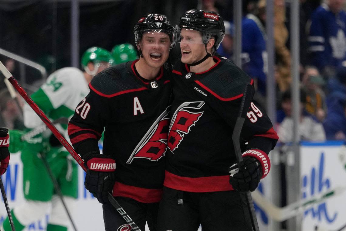 Carolina Hurricanes forward Sebastian Aho (20) congratulates forward Jake Guentzel (59) for scoring the winning shootout goal against the Toronto Maple Leafs on Saturday.